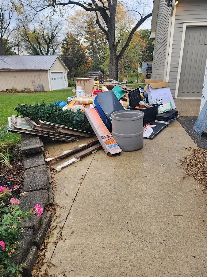 Dumpster being loaded with debris for Estate Cleanout Dumpster Rental in Lake